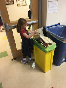A student sorts out compost from recyclables. 